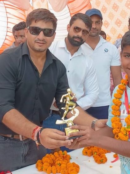 A young champion in the making. Awarding a trophy to one of our junior athletes, inspiring the next generation to aim high.