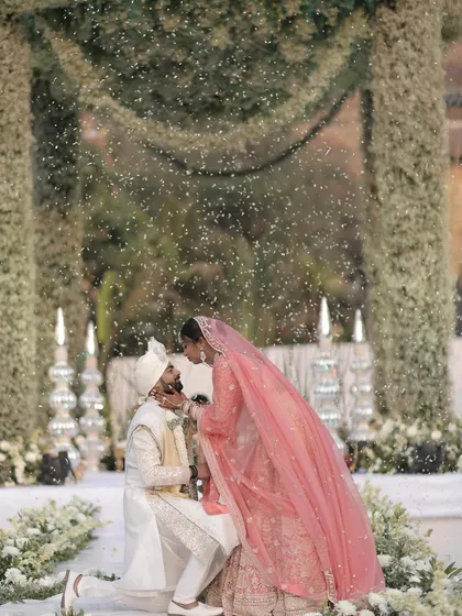 A truly magical varmala ceremony, where the couple is showered in petals under a canopy of lush white baby's breath. I designed this moment to feel like a scene from a dream, focusing on elegant floral decor and creating an unforgettable memory.