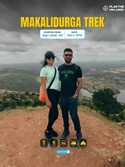 A couple posing on the Makalidurga trek, a perfect quick getaway from Bangalore.