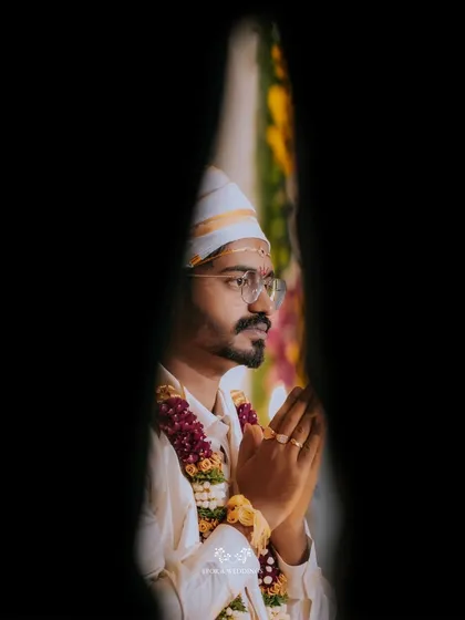 An artistic, framed portrait of the groom in prayer, capturing a moment of quiet devotion.