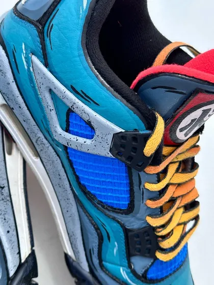 A side detail shot of the Dragon Ball Z custom Jordans. The speckle effect on the grey panels adds a bit of texture and grit to the overall design.