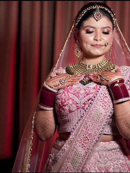 The bride holding her hands to her heart, a gesture of love and happiness.