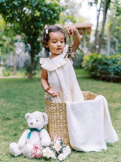 A two-year-old girl playing with an Eiffel Tower prop. It's always a pleasure to catch up with families and see how the children have grown.