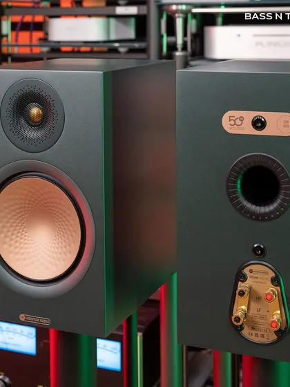 The front and back of the Monitor Audio Silver 100 7G, highlighting the C-CAM gold dome tweeter and the rear-ported design for improved bass response.