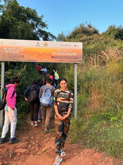 A trekker at the entrance of the Skandagiri trail, ready to begin the climb.