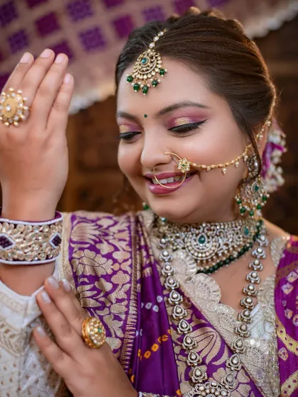 A candid moment showing the bride adjusting her jewelry, her makeup looking flawless.
