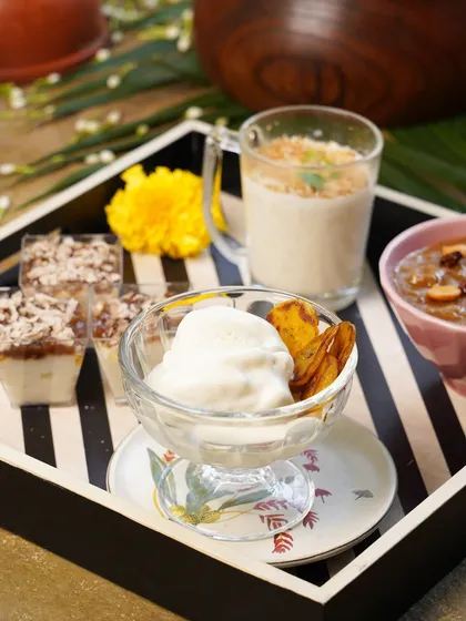 A dessert platter from one of my pop-ups. It features a variety of sweet treats, including payasam, tender coconut ice cream with fried banana, and other delightful creations.
