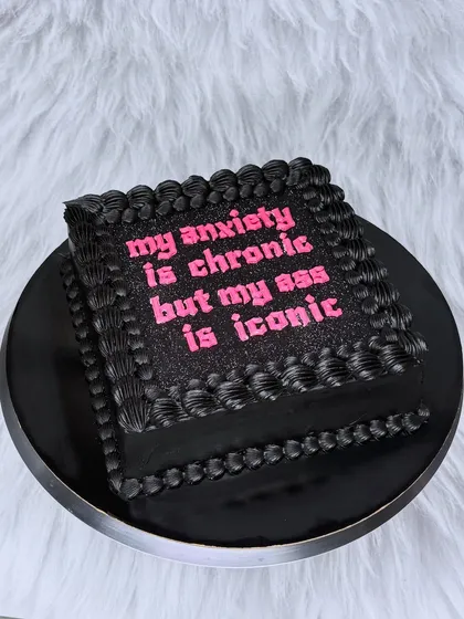 This is for everyone who knows their worth. A black buttercream cake with glittery pink text that says it all: "my anxiety is chronic but my ass is iconic". Let's celebrate you, your confidence, and your iconic self with a cake that's just as bold.