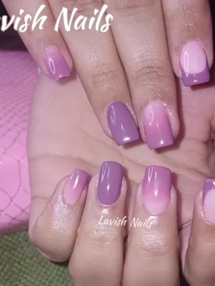 A unique ombre design blending from sheer pink to a solid mauve, with some nails featuring a French tip style.
