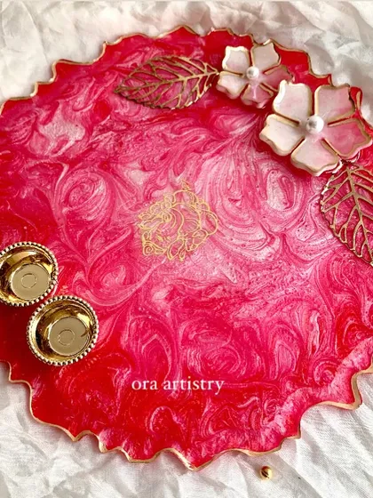 A vibrant pink resin platter with 3D floral and leaf details. This piece is perfect as a decorative tray or for serving special treats.