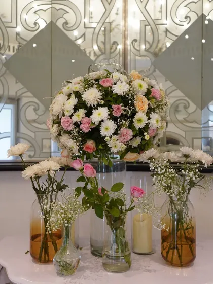 A beautiful, large floral arrangement of white and pink chrysanthemums and roses, perfect as a statement piece for an entrance or stage corner.