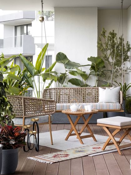 We styled the KAIA balcony to be a warm, inviting deck, designed as a lush retreat for family get-togethers. To create a sanctuary-like atmosphere, we introduced a variety of potted plants, a comfortable outdoor seating arrangement, and a handcrafted swing that evokes nostalgia and comfort.