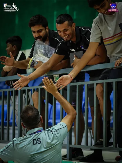 High-fives all around. The team celebrating with the management after the semi-final.