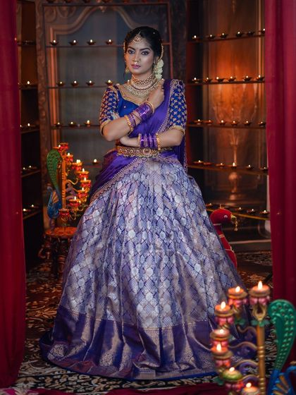 A full-length view of the purple and silver brocade lehenga, paired with our traditional gold-plated jewellery.