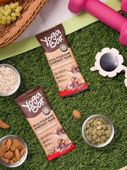 A flat lay of a multigrain energy bar in a picnic setting. We create lifestyle scenes that tell a story about the product, in this case, a healthy on-the-go snack.