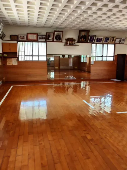 The empty floor of the Shorin-ryu Shorinkan Honbu Dojo in Okinawa. This space is sacred, holding the history and spirit of generations of masters.