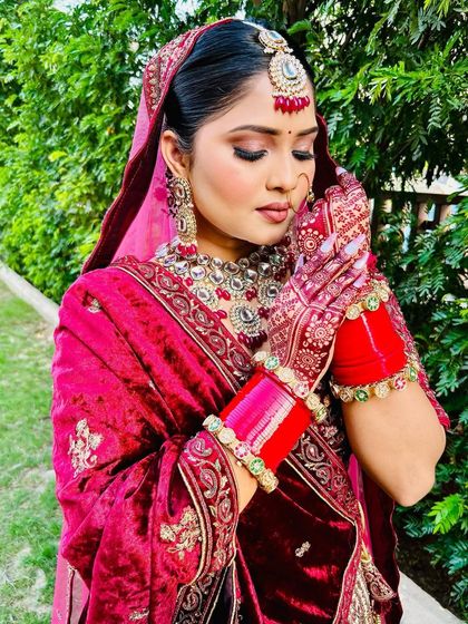 A portrait of the bride, where the rich color of her mehndi is clearly visible, adding to her overall bridal glow.