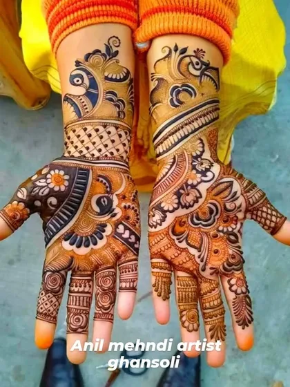 This design features bold peacock figures at the top of each hand. The rest of the pattern is a mix of floral and traditional Indian motifs, creating a vibrant and eye-catching look.