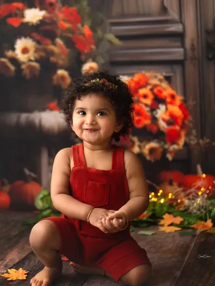 That moment you realize you're the star. Her squishy cheeks and big, beautiful, sparkling eyes are just adorable in this fall-themed toddler shoot.