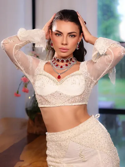 A confident pose in the white lace outfit. The styling is modern and edgy, perfect for an editorial or concept shoot.