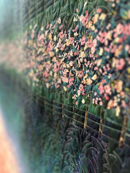 A close-up of a scenic quilt, where our quilting adds texture to the trees and creates a sense of depth.