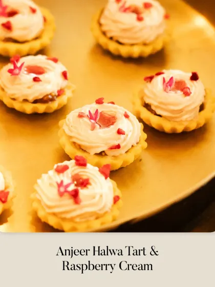 A variation of the Anjeer Halwa Tart, this version is topped with a delicate Raspberry Cream and garnished with edible flower petals, served on a golden platter.