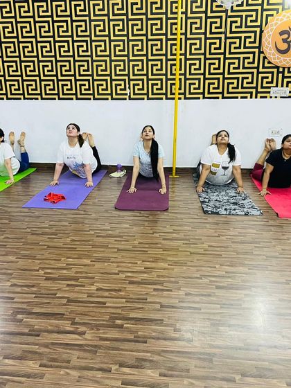 The entire class working on their back flexibility with a variation of the cobra pose. We guide everyone to move at their own pace and listen to their body.