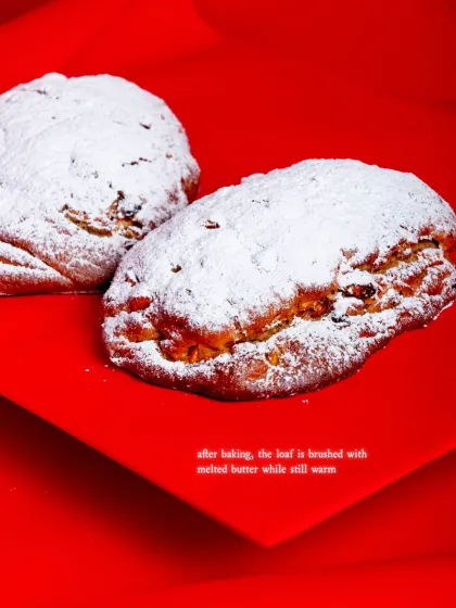 After baking, the loaf is brushed with melted butter while still warm before being dusted with sugar.