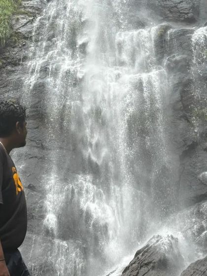 A solo traveler taking in the grandeur of Jhari Falls. Our trips are safe and welcoming for everyone.