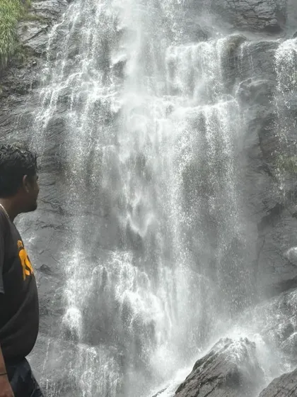 A solo traveler taking in the grandeur of Jhari Falls. Our trips are safe and welcoming for everyone.