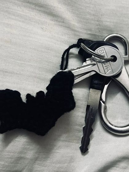 The bat charm can also be used as a keychain. It's a simple silhouette design, crocheted in solid black.