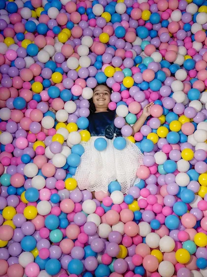 First birthdays are full of wonder and play. This shot of a little one lost in a colorful ball pit shows my ability to capture the pure, unfiltered joy of childhood celebrations.