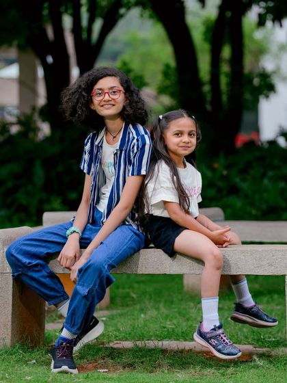 A classic sibling portrait taken on a park bench. I guide my subjects into poses that feel natural, allowing their personalities to shine through.