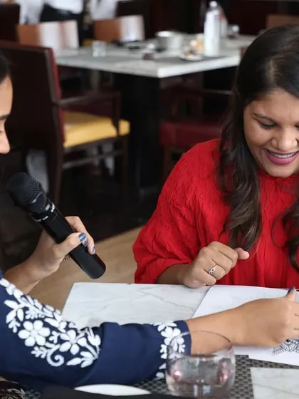 Sharing a laugh with a participant during a workshop. It's not just about the art, it's about having fun and enjoying the moment.