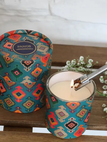 Lighting our scented candle in a vibrant, patterned tin. The ritual of lighting a candle is a moment of peace, and our beautiful designs make that moment even more special.