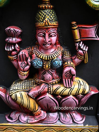 Detail of Vijaya Lakshmi from the vertical Astalakshmi panel, holding her symbolic flag and painted in vibrant hues.