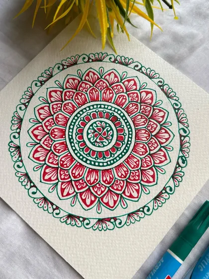 This red and green mandala is simple, yet so satisfying to create. The contrasting colors and clean patterns make it a visually appealing piece that brings a sense of balance and calm.