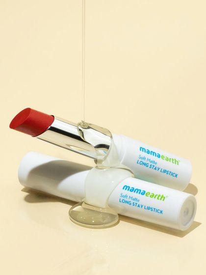 A simpler version of the texture shot, focusing on two lipsticks. The glossy drizzle connects the two products and adds a sense of motion and tactility to a clean, studio setup.