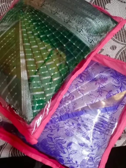 Two sarees packed in custom bags after pleating. This not only keeps them neat but also makes them perfect for gifting or travel.