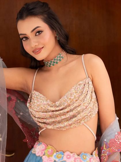 A close-up on the unique draped blouse and the colorful skirt of the Rang lehenga.