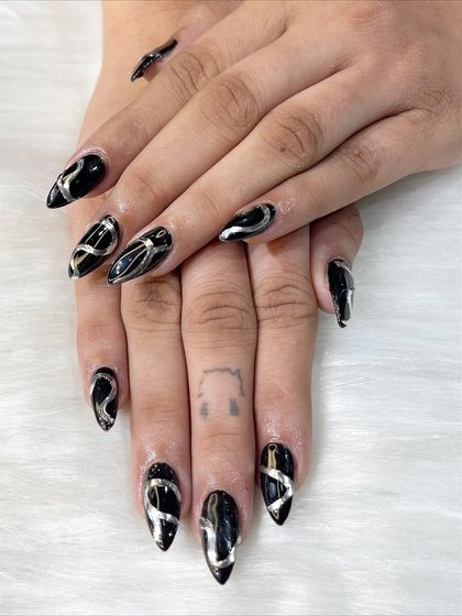 A full hand view of the black and silver design, showing the consistency of the art across all nails.