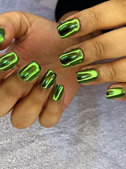 A vibrant green chrome polish on short, square nails for a high-impact, metallic look.
