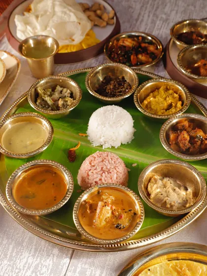 My SONATA (Sadya On A Thali) for Diwali. A full festive spread in individual bowls, featuring both my Superfood Veg Sadya and non-veg Unsadya® options like Varutharacha Chicken Curry.