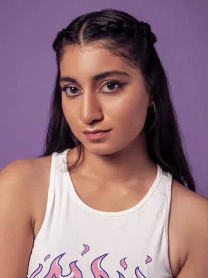 A clean and simple headshot. The purple background makes this a great, colorful addition to a portfolio.