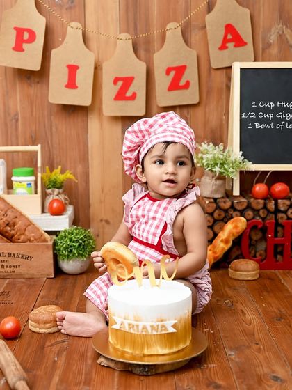 Our little baker is ready for his first cake. This creative pizza and bakery themed shoot is a unique take on the classic cake smash, perfect for a fun-loving family.