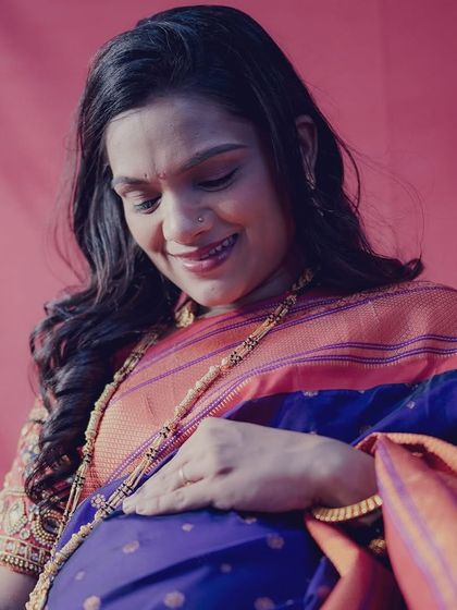 A tender moment captured as the mom-to-be looks down at her baby bump. The soft lighting in the studio creates a warm and intimate feel for these traditional portraits.