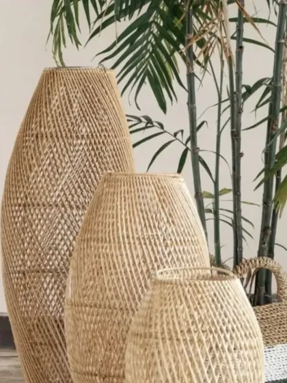 Add a touch of natural elegance to your home with our set of three handwoven rattan and bamboo floor vases. Their intricate texture and organic shape make them a stunning focal point, perfect for displaying dried botanicals or standing alone as sculptural art.