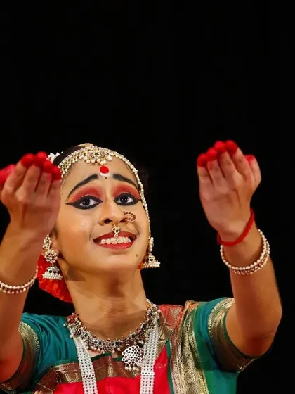 A close-up of my student Sahana during her debut, showcasing the intricate 'hasta mudras' or hand gestures that form the vocabulary of classical dance.