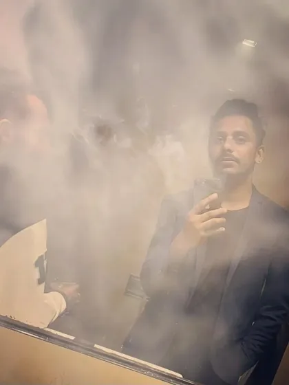 A smoky, atmospheric shot with a friend. The vibe of the green room is just as important as the vibe on stage.