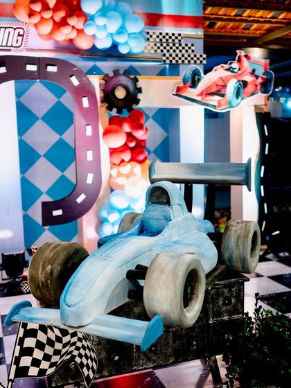 A large 3D prop of a blue formula one race car, a major highlight of the racing-themed decorations.